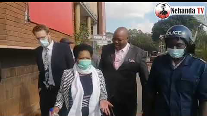 Lawyer Beatrice Mtetwa being escorted by riot police