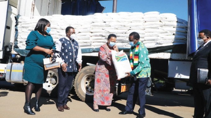 President Emmerson Mnangagwa receives the first batch of 5 625 tonnes of maize-meal donated by South Africa towards Cyclone Idai victims from SA’s International Relations and Cooperation Minister Grace Naledi Pandor, while Vice President Constantino Chiwenga and Foreign Affairs and International Trade Minister Fredrick Shava (far right) look on at State House in Harare. — Picture: Tawanda Mudimu
