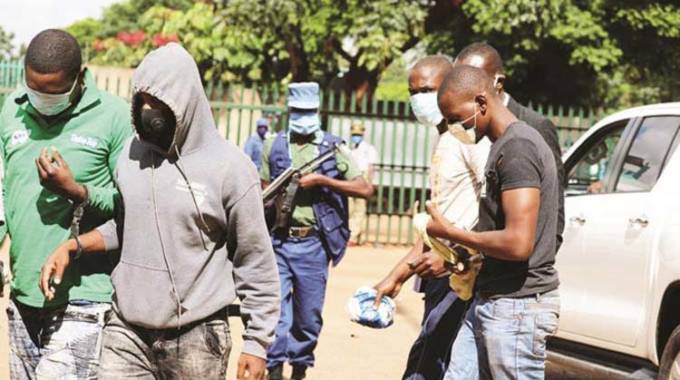 File picture of robbery suspects being taken to court