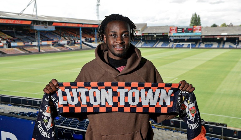 Zimbabwe international forward, Admiral Muskwe proudly displays a Luton Town scarf, after joining the English side.