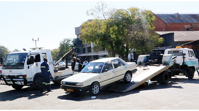 Bulawayo City Council was last week in a clamping blitz, towing vehicles being washed at undesignated points in the city centre. The picture shows council workers towing a vehicle from a parking bay along George Silundika Street