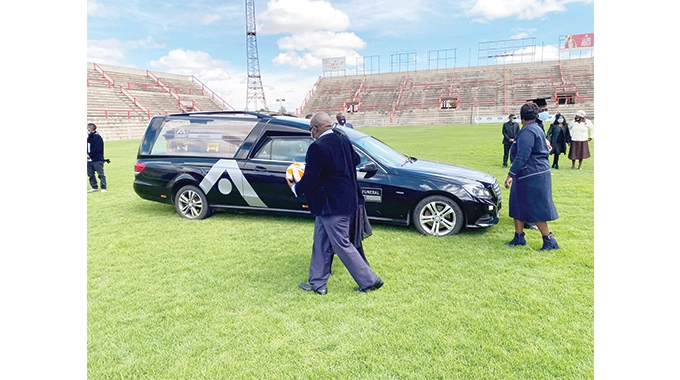 A hearse takes Ernest “Maphepha” Sibanda’s body to Barbourfields Stadium before his burial service yesterday