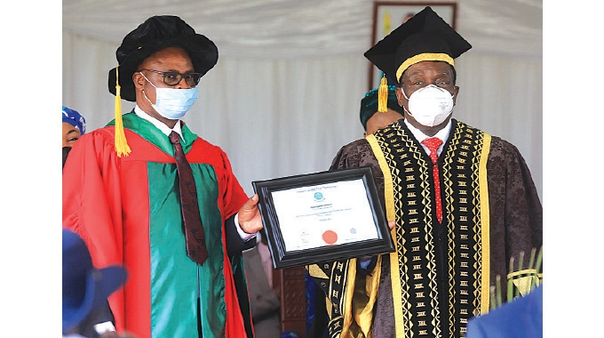 President Mnangagwa poses for a picture with Chinhoyi Commercial farmer Tinashe Ziki after being awarded an Honorary Doctorate Degree at Chinhoyi University of Technology yesterday.-Picture: Tawanda Mudimu.