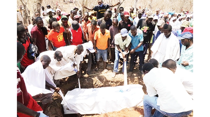 The coffin bearing Tendai Marera's body being lowered into his final resting place in Marymount, Rushinga, yesterday