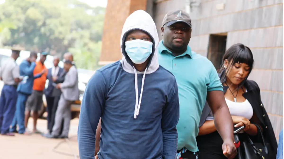 Zimdancehall producer Tafadzwa Kadzimwe aka DJ Levels arrives at the Harare Magistrates Court accompanied by DJ Fantan (in shorts) to face allegations of raping singer Shashl. The charges were later amended — Picture: Lee Maidza via The Herald)