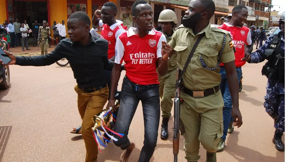 One fan was carrying a symbolic trophy which they had bought at a store (Picture via Jacobs Odongo Seaman - BBC)