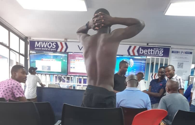 Social media is awash after a Harare man removed all his clothes and left himself in his birthday suit after losing a bet at MWOS Betting House recently. (Picture via @Hwency263 on Twitter)
