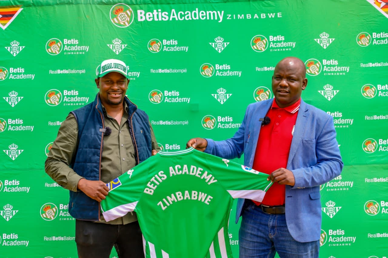 Real Betis Zimbabwe president Gerald Sibanda presents the academy's replica jersey to the Mayor of Bulawayo Solomon Mguni in 2022