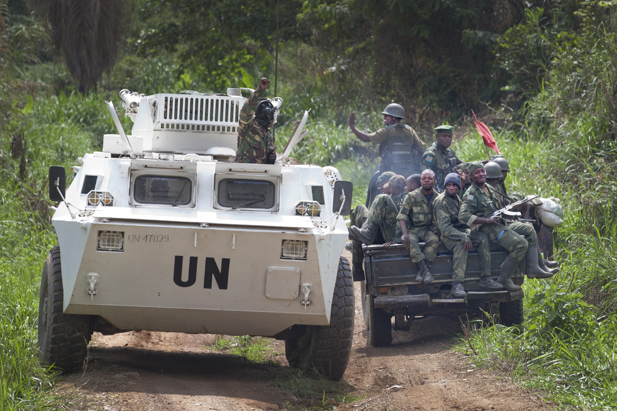 A MONUSCO APC is greeted by FARDC soldiers on their way back from the front line in the Beni region where the UN is backing the FARDC in an operation against ADF militia, the 13th of March 2014. © MONUSCO/Sylvain Liechti