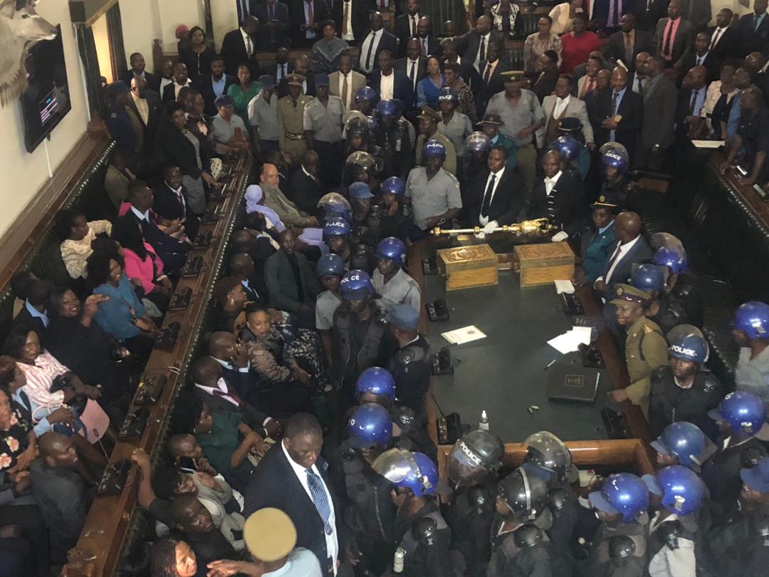 Police state ... police entered the legislative chamber to wrestle CCC MPs out of parliament on Tuesday 10 October 2023 (Picture via ZimLive)