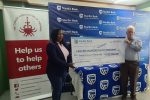 Stanbic Bank donates US$20 000 for chemotherapy drugs to CAZ Stanbic Bank Manager, Brand and Advertising, Tariro Memo (left) hands over the dummy US$20 000 cheque for chemotherapy drugs to CAZ Board Treasurer, Don MacDonald.