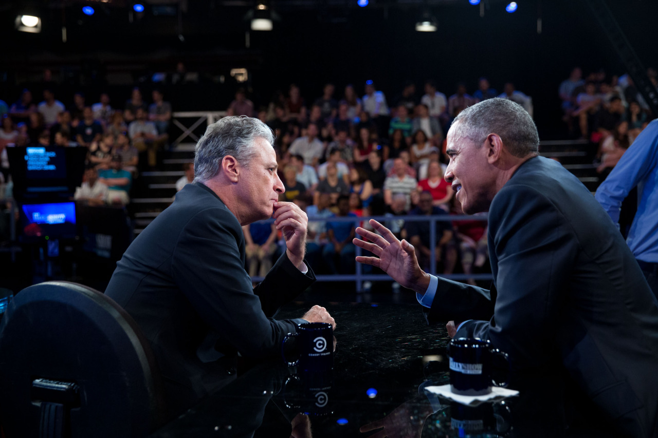 President Barack Obama talks with Jon Stewart between segments of The Daily Show with Jon Stewart in New York, N.Y., July 21, 2015 (Picture via Pete Souza, Public domain, via Wikimedia Commons)