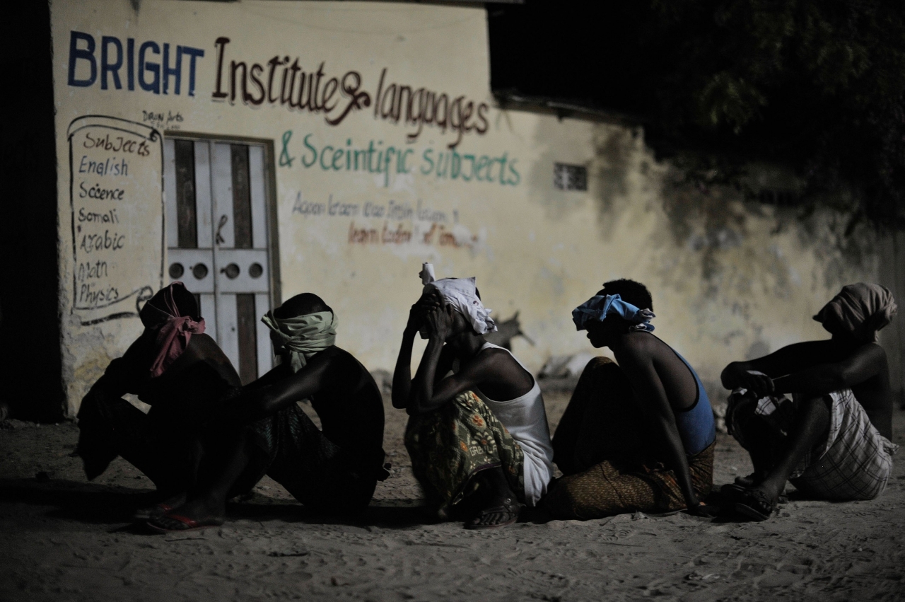 Suspected al Shabab militants wait to be taken off for interrogation during a joint night operation between the Somali security services and AMISOM forces in Mogadishu, Somalia, on May 4. (AU UN IST PHOTO / Tobin Jones)
