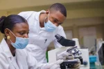 Zimbabwe selected for global rollout of breakthrough HIV prevention drug A young African female research scientist and senior male supervisor analyzing microscope slides (Picture by Wirestock via DepositPhotos.com)