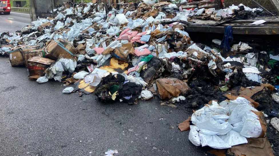 Burned items from the lorry were left on the road (Picture via T J Cottis Transport Ltd)